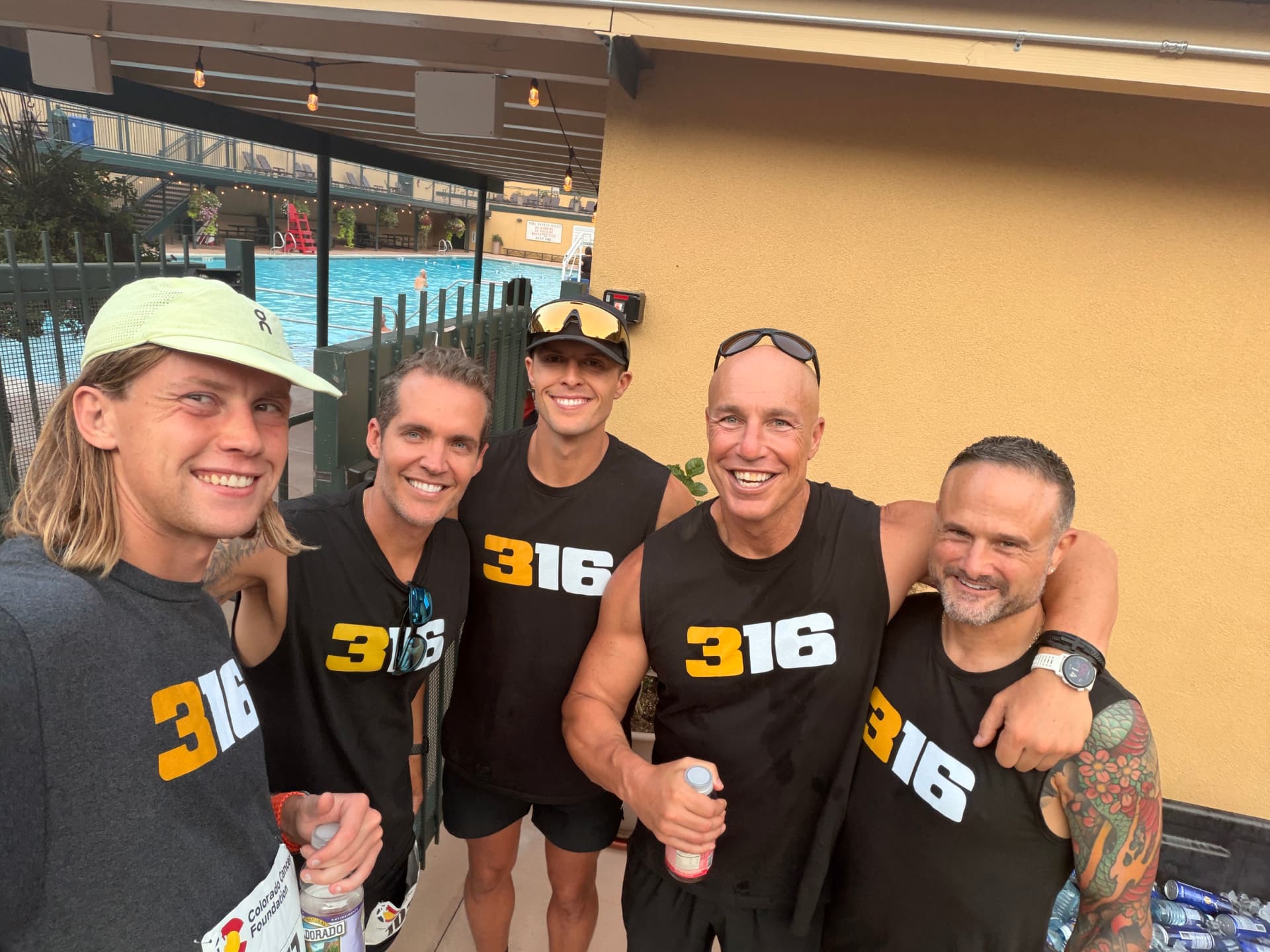 Five 316 runners celebrating together after the race