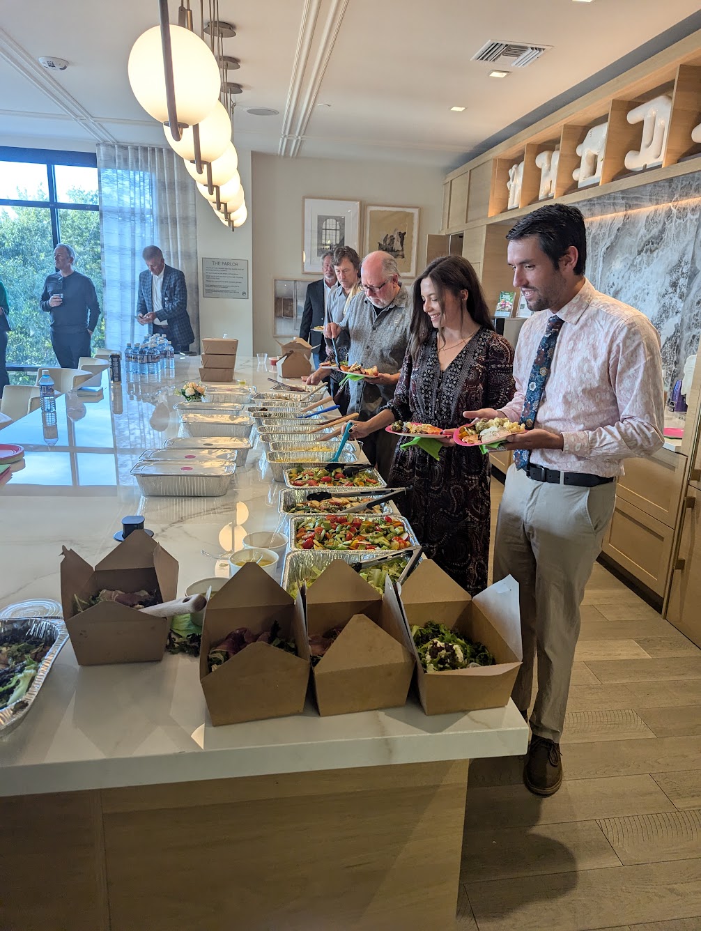 Guests serving food at a Cherry Creek gathering